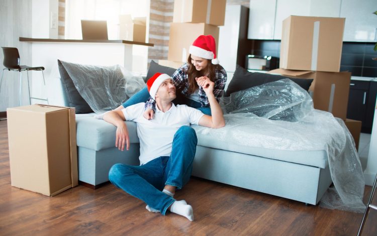 young couple in new home for first christmas together