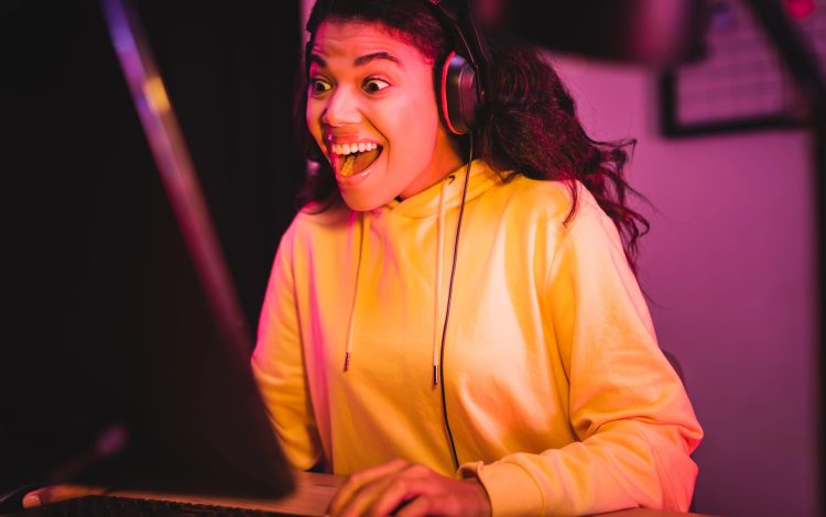 young girl laughing playing computer games