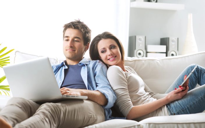 couple creating gift registry together on computer