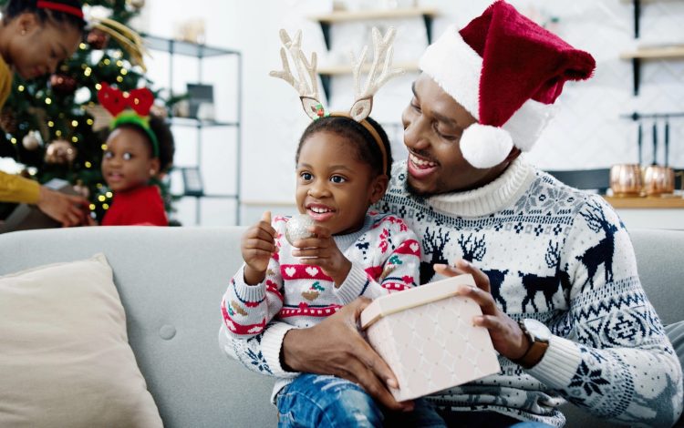 dad with santa hat on with son on lap