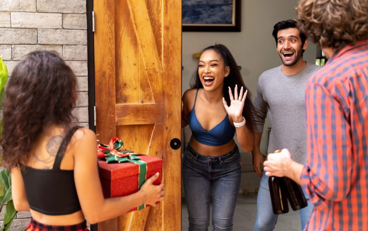 couple receiving housewarming party guests