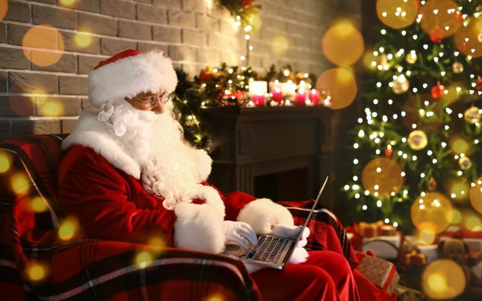 santa in chair by x mas tree