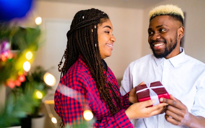 beautiful family holding gift box celebration xmas at home