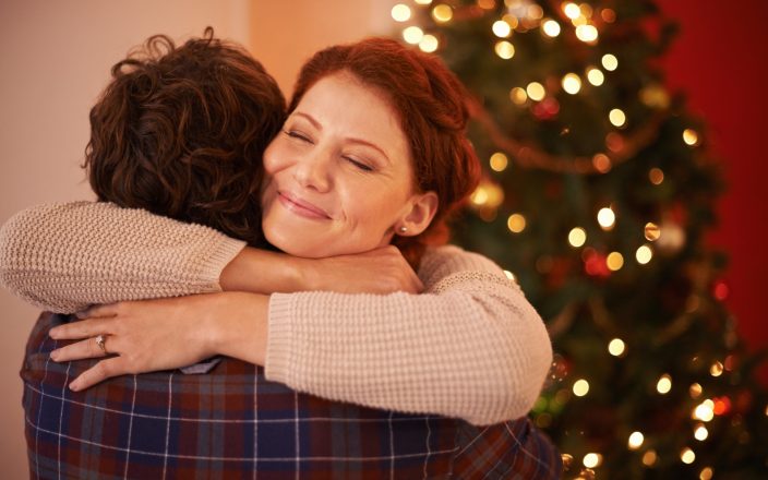 Christmas hug. Shot of an affectionate young couple embracing at Christmas time