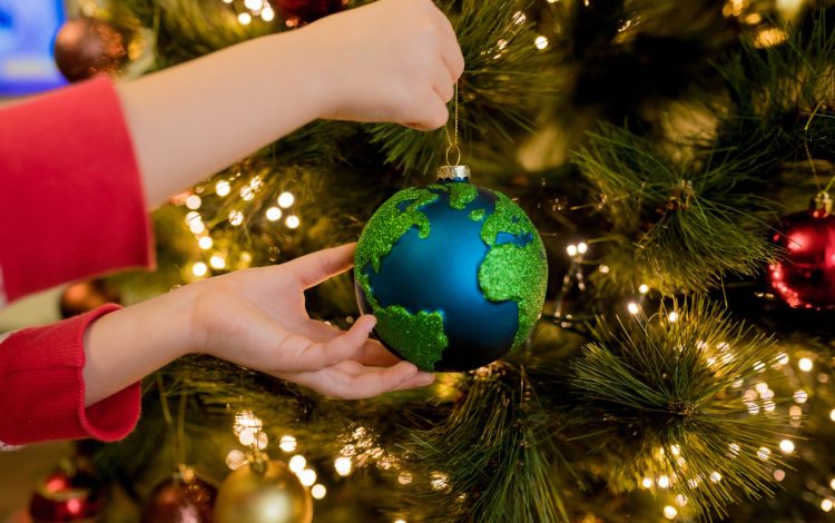 close-up-of-little-girl-hanging-xmas-glass-bauble