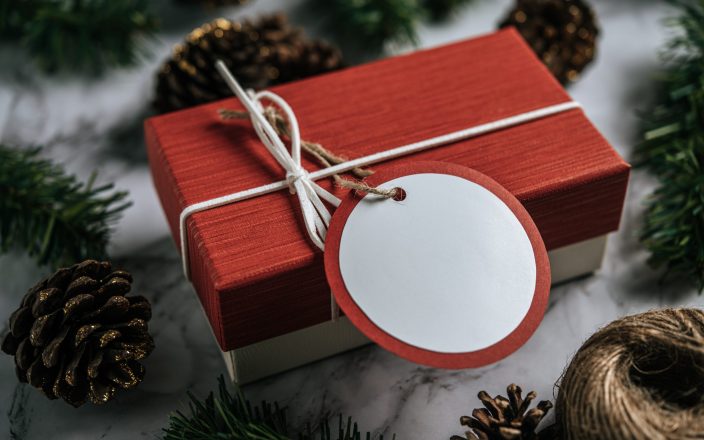 Gift boxes with small gifts on white cement