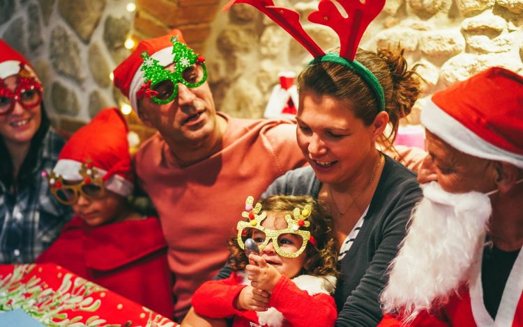 Happy family having fun at dinner during Christmas time - Focus on little girl hands